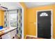 Bright dining area with a large window and stylish yellow accent wall at 14019 Notreville Way, Tampa, FL 33624