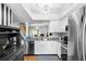 Modern kitchen with granite countertops, stainless steel appliances, and white cabinetry at 14019 Notreville Way, Tampa, FL 33624