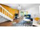 Bright living room features stylish decor, hardwood floors, a chandelier, and an exit to the outdoors at 14019 Notreville Way, Tampa, FL 33624