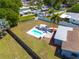 Expansive backyard featuring a pristine pool, patio furniture, and lush green lawn at 1541 68Th N Ave, St Petersburg, FL 33702