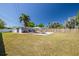 Expansive backyard showcasing a pool, ample seating, and mature trees, perfect for outdoor living at 1541 68Th N Ave, St Petersburg, FL 33702