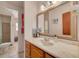Bathroom featuring a large framed mirror, vanity with drawers and storage, and access to a shower at 1541 68Th N Ave, St Petersburg, FL 33702