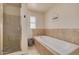 Serene bathroom featuring a soaking tub, separate shower with glass door, and a tranquil aesthetic at 1541 68Th N Ave, St Petersburg, FL 33702