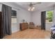 Cozy bedroom with warm wood laminate floors, neutral walls, and plenty of natural light from two windows at 1541 68Th N Ave, St Petersburg, FL 33702