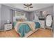 Comfortable bedroom with a ceiling fan, wood laminate flooring, and white wood furnishings at 1541 68Th N Ave, St Petersburg, FL 33702