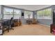 Versatile bonus room with large windows, a desk setup, and a cozy seating area at 1541 68Th N Ave, St Petersburg, FL 33702