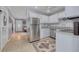 Bright kitchen with white cabinets, stainless steel appliances, and a stylish tile floor at 1541 68Th N Ave, St Petersburg, FL 33702