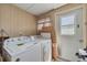 Functional laundry area with washer, dryer, and natural light, great for household chores at 1541 68Th N Ave, St Petersburg, FL 33702
