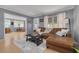 Comfortable living room showcasing a plush leather sofa, decorative rug, and bright natural light at 1541 68Th N Ave, St Petersburg, FL 33702