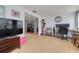 Open-concept living space with a modern TV, cozy seating, and a functional workspace, all bathed in natural light at 1541 68Th N Ave, St Petersburg, FL 33702