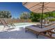 Relaxing poolside view with comfortable lounge chairs and a shaded umbrella, perfect for enjoying sunny days at 1541 68Th N Ave, St Petersburg, FL 33702
