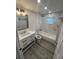 Modern bathroom featuring a vanity with drawers, a bathtub with tiled walls, and stylish fixtures at 1574 Ewing Ave, Clearwater, FL 33756