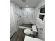 Bathroom with white marble tiled shower and a gray vanity sink at 1574 Ewing Ave, Clearwater, FL 33756