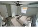 Cozy bedroom with a ceiling fan, bright window, and comfortable furnishings at 1574 Ewing Ave, Clearwater, FL 33756
