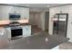 Modern kitchen showcasing a central island, stainless steel appliances and ample cabinet space at 1574 Ewing Ave, Clearwater, FL 33756