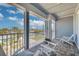 Relaxing balcony with pavers, white chairs, and beautiful neighborhood views under a blue sky at 16306 1St E St, Redington Beach, FL 33708