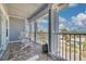 Scenic balcony view with comfortable seating, offering a relaxing outdoor space with neighborhood views at 16306 1St E St, Redington Beach, FL 33708