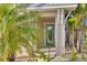 Inviting entryway with a blue door and lush greenery in a tropical setting at 16306 1St E St, Redington Beach, FL 33708