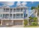 Charming multi-story condo with balconies, garages, and lush tropical landscaping at 16306 1St E St, Redington Beach, FL 33708