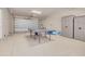 Functional garage space with ample room for storage, featuring a ping pong table and a kayak for recreational activities at 16306 1St E St, Redington Beach, FL 33708