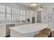 Elegant white kitchen featuring a spacious island with seating and stainless steel appliances at 16306 1St E St, Redington Beach, FL 33708