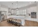Bright and modern kitchen with white cabinets, stainless appliances, and large island at 16306 1St E St, Redington Beach, FL 33708