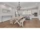 Bright kitchen with white cabinets, stainless steel appliances, a large island, and a dining area with a chandelier at 16306 1St E St, Redington Beach, FL 33708