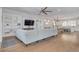 Open-concept living space connecting the kitchen to the living room with hardwood floors at 16306 1St E St, Redington Beach, FL 33708