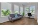 Bright and airy living room with large windows showcasing lush greenery and stylish furnishings at 16306 1St E St, Redington Beach, FL 33708
