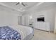 Bright bedroom boasts tray ceiling, white dresser with TV, and plush carpet at 16306 1St E St, Redington Beach, FL 33708