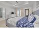 Bright main bedroom featuring tray ceiling, balcony access, dresser with TV, and en-suite bathroom at 16306 1St E St, Redington Beach, FL 33708
