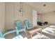 Relaxing patio space with comfortable blue Adirondack chairs and a wooden coffee table for outdoor gatherings at 16306 1St E St, Redington Beach, FL 33708