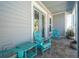 Inviting porch with blue Adirondack chairs, perfect for enjoying outdoor relaxation at 16306 1St E St, Redington Beach, FL 33708