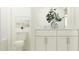 Bright bathroom featuring double sinks, modern white cabinets, and decorative accents at 17560 Happytrails St, Land O Lakes, FL 34638