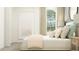 Comfortable bedroom featuring neutral decor, window view and beach themed artwork at 17560 Happytrails St, Land O Lakes, FL 34638