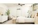 Comfortable main bedroom featuring stylish decor, a ceiling fan, and a full length mirror offering relaxation at 17560 Happytrails St, Land O Lakes, FL 34638