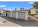 Well-maintained detached garages featuring gray doors and convenient access, with nearby accessible ramp at 1998 Blue Hawk Ct # 1613, Clearwater, FL 33762