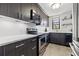 Well-lit kitchen featuring stainless steel appliances and sleek dark cabinetry at 1998 Blue Hawk Ct # 1613, Clearwater, FL 33762