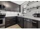 Modern kitchen with stainless steel appliances, sleek cabinets, and quartz countertops at 1998 Blue Hawk Ct # 1613, Clearwater, FL 33762