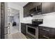 Updated kitchen featuring stainless steel appliances and stylish dark wood cabinetry at 1998 Blue Hawk Ct # 1613, Clearwater, FL 33762