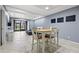 Bright living room boasts tile floors, recessed lighting and a dining nook with a wooden table at 1998 Blue Hawk Ct # 1613, Clearwater, FL 33762