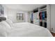 Spacious bedroom with closet featuring sliding doors and built-in shelving, plus a view to the outside at 1998 Blue Hawk Ct # 1613, Clearwater, FL 33762