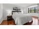Bright main bedroom with king bed, wood floors and beautiful window view to the outside at 1998 Blue Hawk Ct # 1613, Clearwater, FL 33762