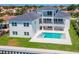 Beautiful backyard featuring a modern pool, jacuzzi, patio, and manicured lawn, perfect for outdoor living at 2050 Hawaii Ne Ave, St Petersburg, FL 33703