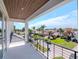 Balcony with metal railing overlooks landscaped street with palm trees at 2050 Hawaii Ne Ave, St Petersburg, FL 33703