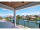 From the covered balcony, a picturesque view shows waterway, complemented by a wood ceiling and sleek railings at 2050 Hawaii Ne Ave, St Petersburg, FL 33703