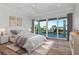 Bedroom with hardwood floors and sliding doors to the balcony at 2050 Hawaii Ne Ave, St Petersburg, FL 33703