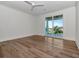Bright room with hardwood floors and a sliding glass door leading to a balcony with water views at 2050 Hawaii Ne Ave, St Petersburg, FL 33703