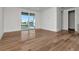 Bedroom featuring hardwood floors and a sliding glass door that leads to a balcony with waterfront views at 2050 Hawaii Ne Ave, St Petersburg, FL 33703