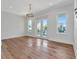 A sun-filled room with an elegant chandelier, beautiful hardwood floors, and a view of the outdoors at 2050 Hawaii Ne Ave, St Petersburg, FL 33703